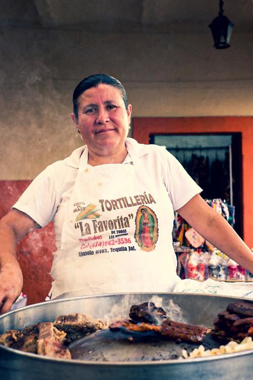 Das Foto zeigt eine Frau, die „Tortas“ (ein typisches mexikanisches Gericht) auf einem Lebensmittelmarkt in Tequila, Jalisco verkauft.